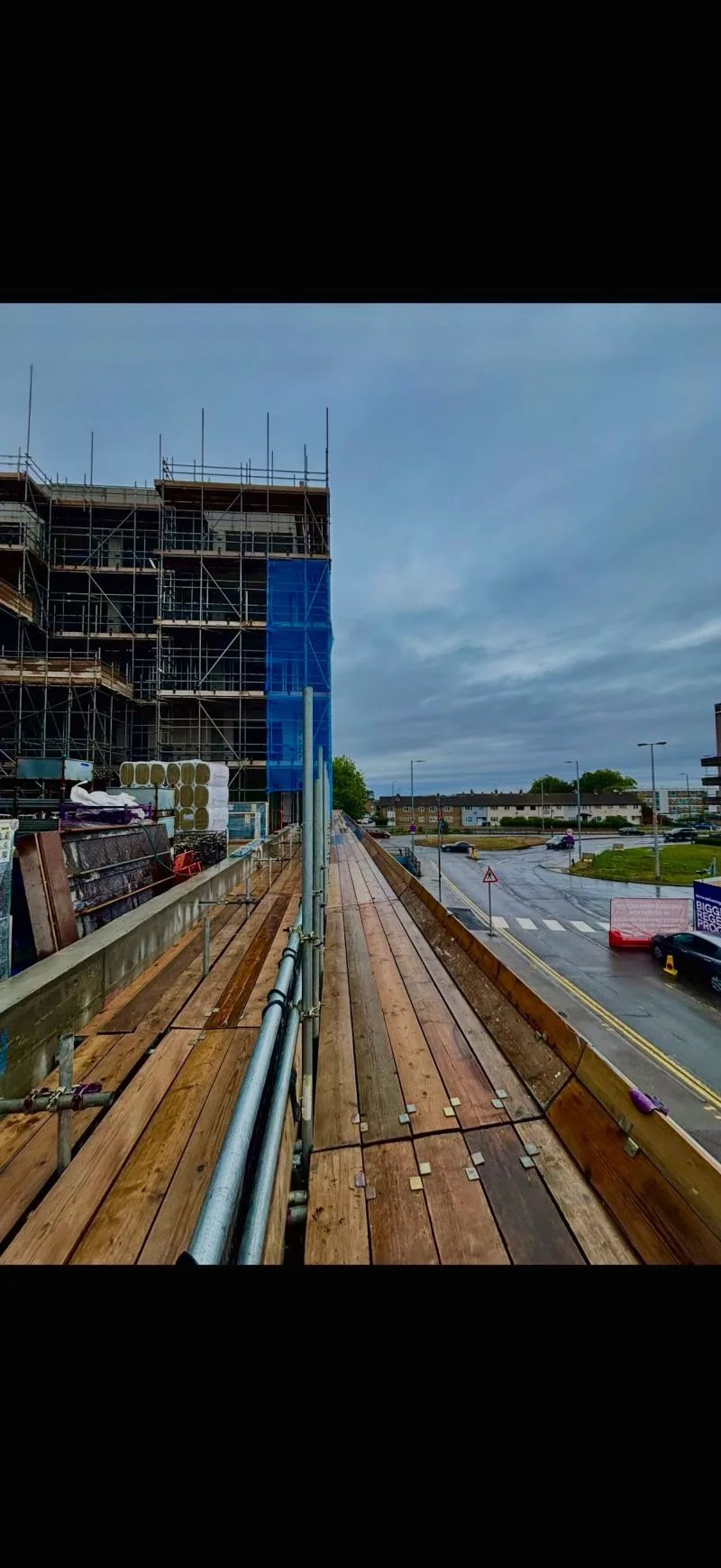 Occasio House scaffold walkway showing hoarded perimeter and streetscape